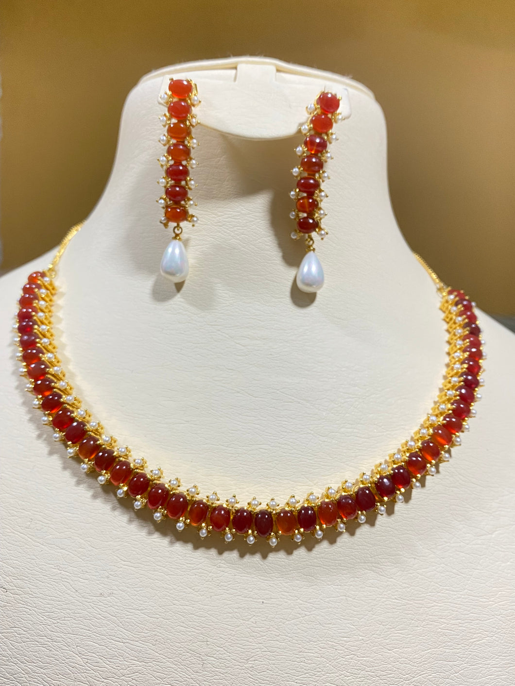 Orange stone and pearl necklace and earrings.